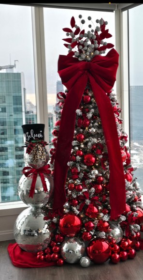 Styled Christmas tree with red velvet ribbon and silver ornaments