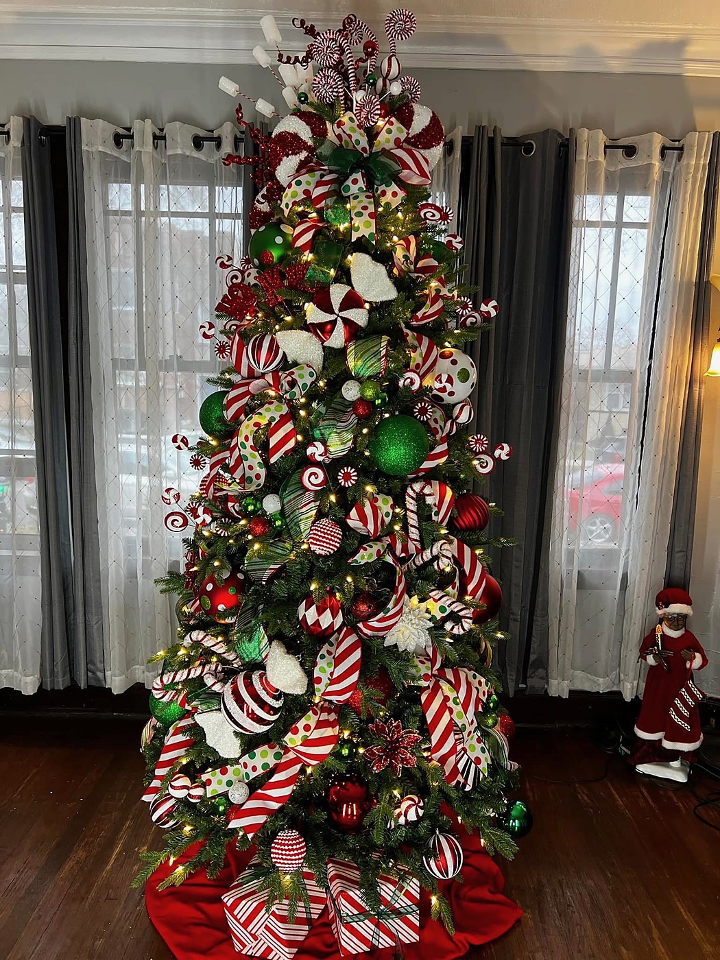 Red, green, and white peppermint themed Christmas tree