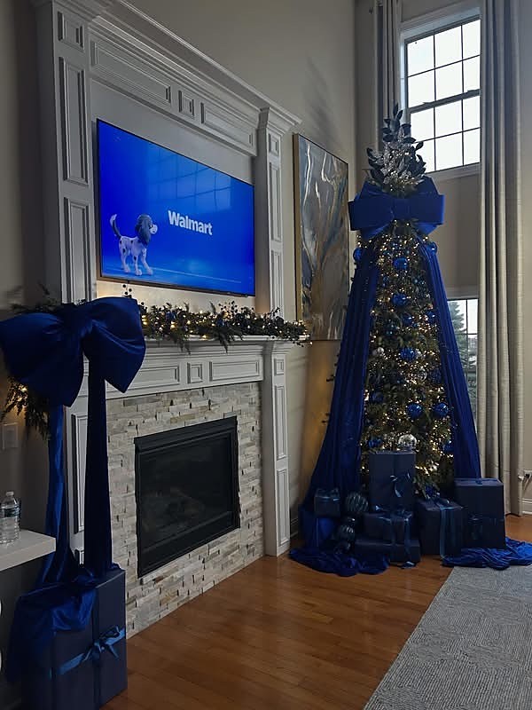 Royal blue Christmas tree and mantel styled by a fireplace