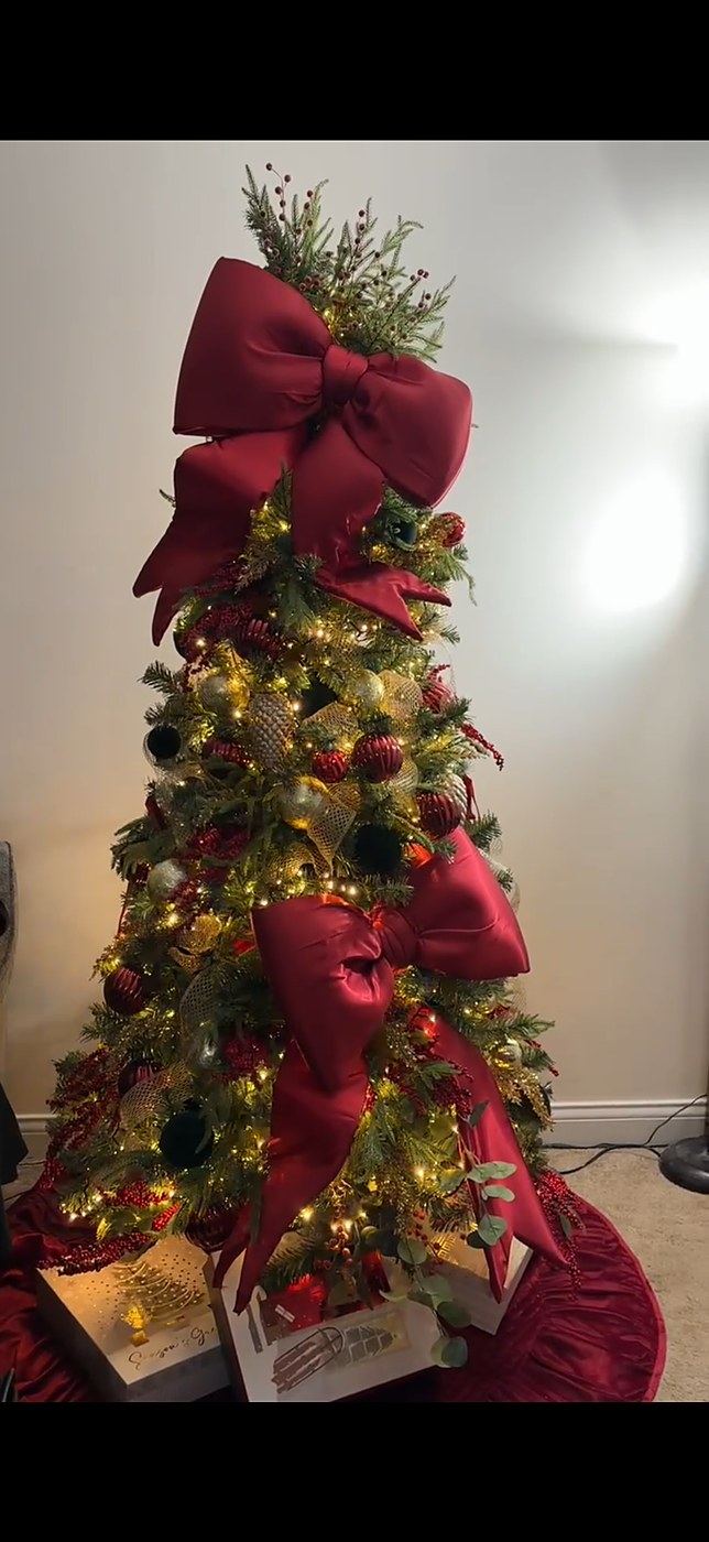 Classic red and gold Christmas tree with oversized velvet bows